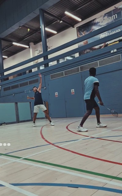 Badminton court mid-rally